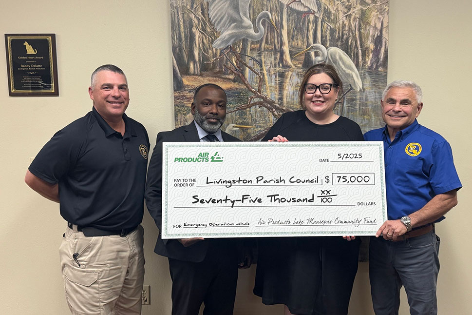Air Products employees Stainley Bienemy and Christina Stephens join Livingston Parish President Randy Delatte for a check presentation.